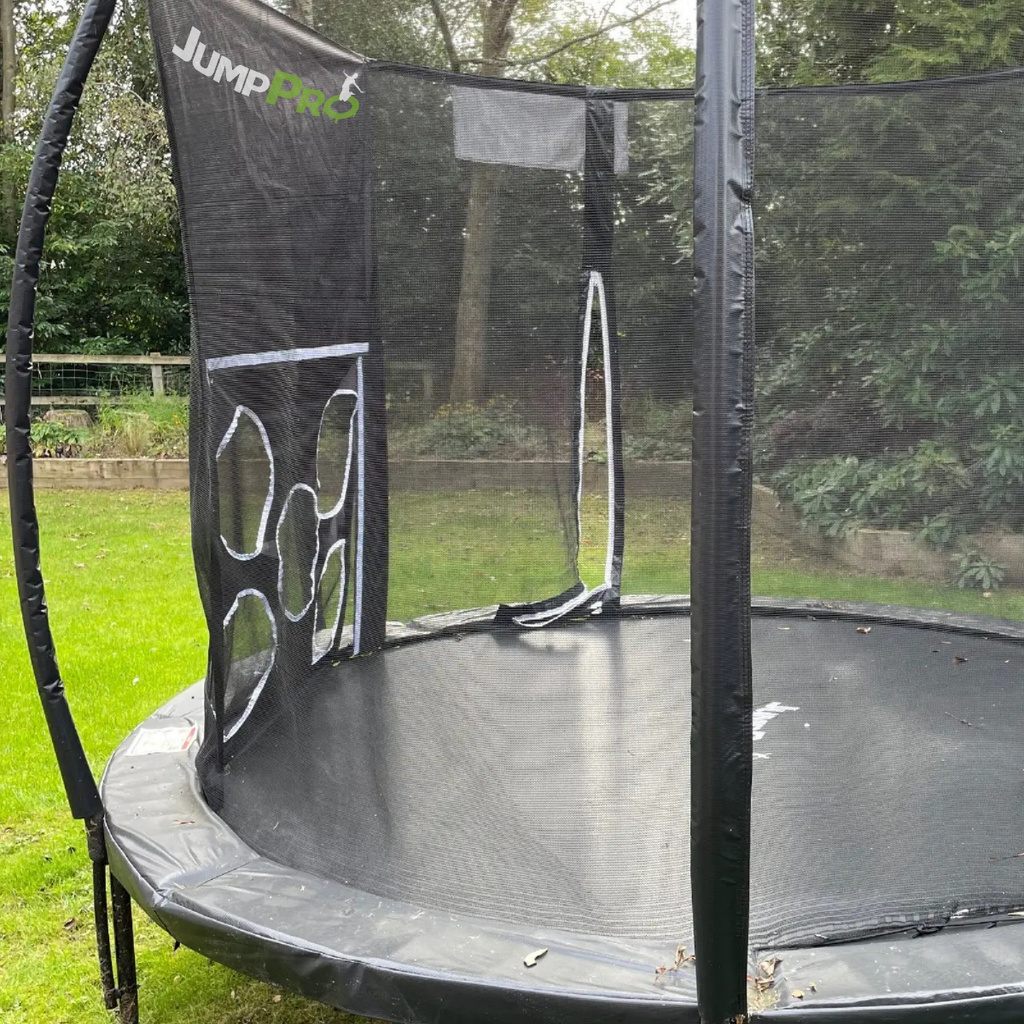 Trampoline with safety net in a grassy outdoor area
